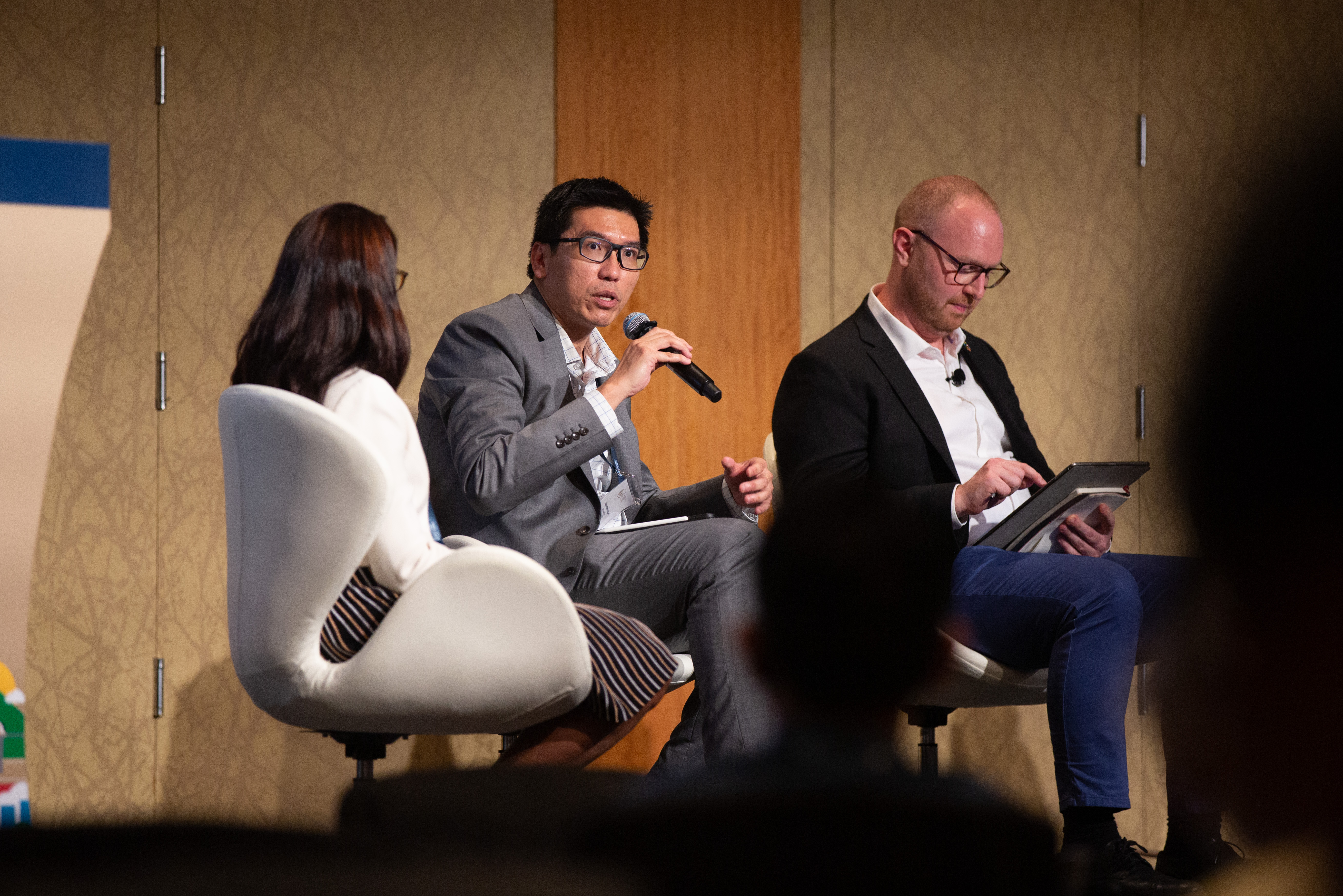 Prof Winston Chow sitting with two other people during a panel discussion for World Cities Summit