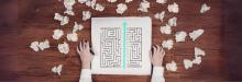 A figurative thumbnail of a maze and an arrow straight across with crumpled papers surrounding it. The maze represents a complex problem, the straight arrow symbolises smart heuristics and the crumpled papers symbolise more traditional methods that may not always be successful. 